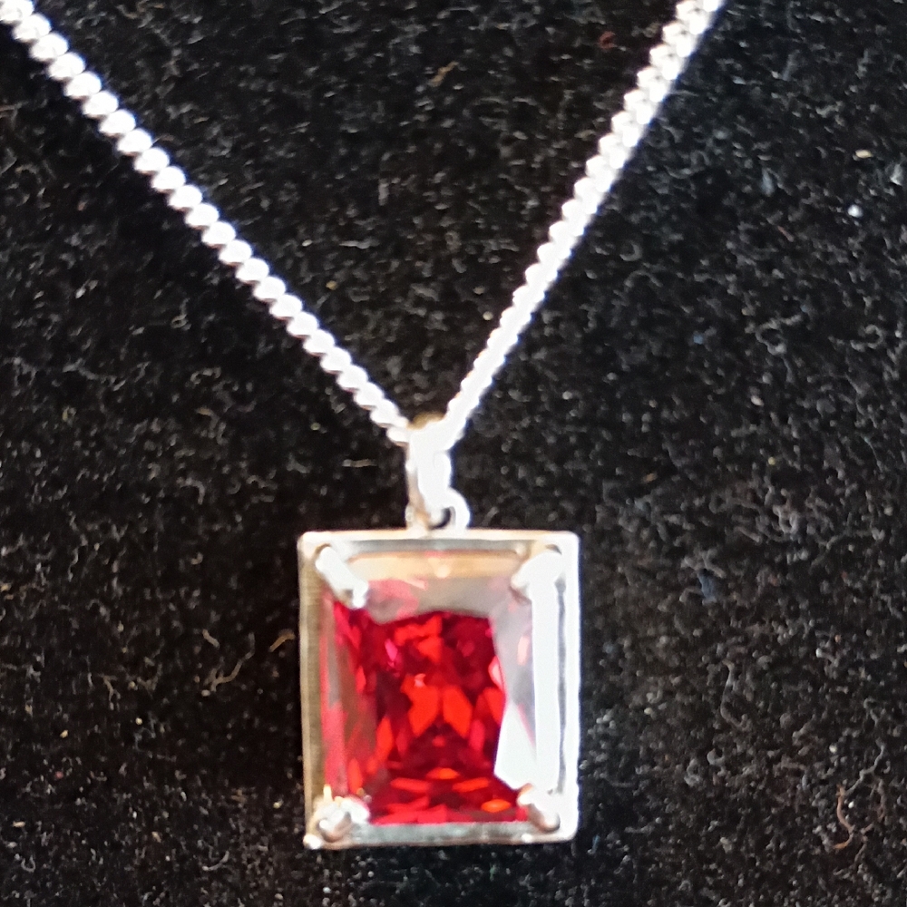 Radiant Silver Necklace with Red Gemstone